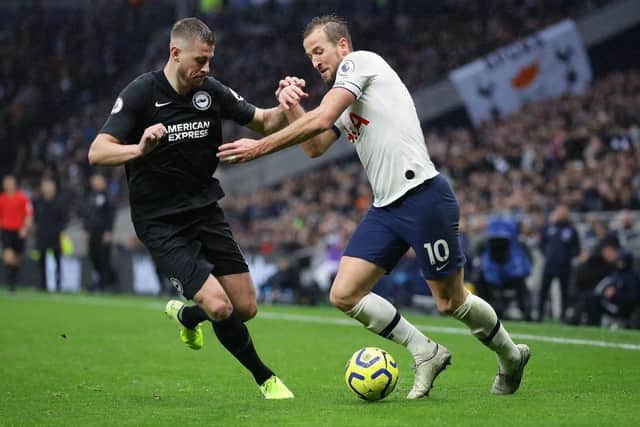 Adam Webster, who opened the scoring for Brighton, tussles with Harry Kane, who equalised for Spurs