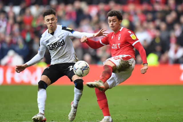 Brennan Johnson of Nottingham Forest battles for possession with Lee Buchanan of Derby County during the Sky Bet Championship match between Nottingham Forest and Derby County at City Ground on January 22, 2022