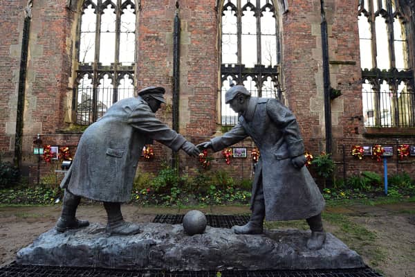 A resin model of a sculpture illustrating the WW1 Christmas Truce football match is pictured during a photocall inside the remains of St Luke's Church in Liverpool