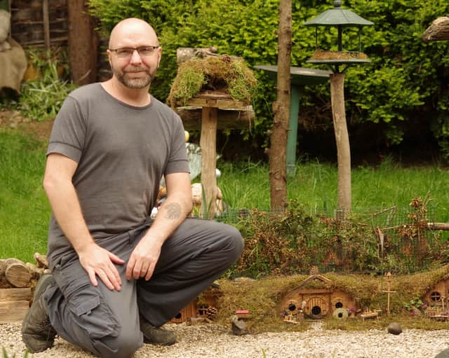 Simon Dell with the mice houses he has created in his garden in Sheffield, South Yorkshire. 