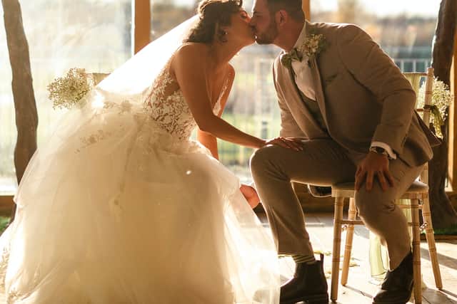 A bride given less than six months to live after losing her leg to cancer made it down the aisle to marry her partner -for the second time.