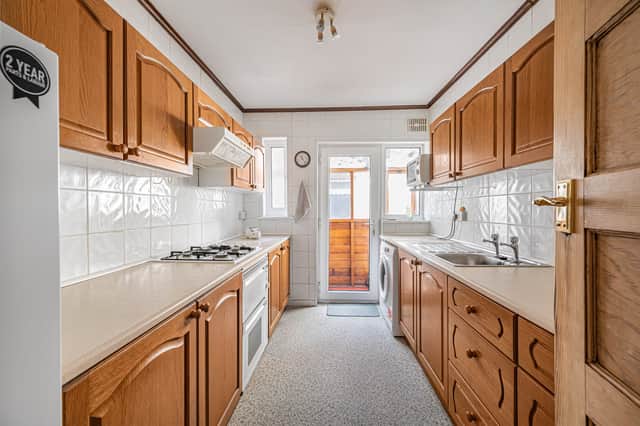 The kitchen includes an oven, hob and extractor as part of the bungalow's practical layout