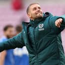 Brighton boss Fabian Hurzeler celebrates with the fans after victory at Sunderland