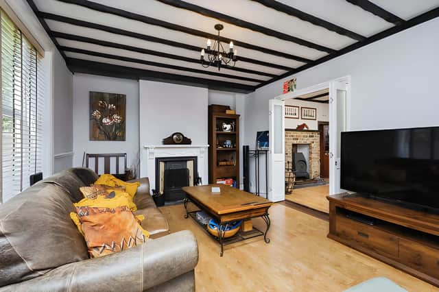 Exposed beams and a study area give the main reception room character