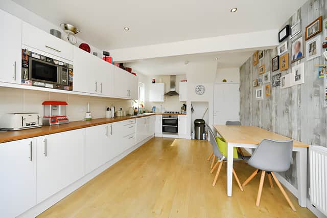 A modern kitchen/diner provides a practical hub for everyday life, with bi-fold doors connecting the cooking and dining space to the extensive rear garden