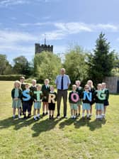 Pupils helping the Headteacher to celebrate our amazing Ofsted inspection result
