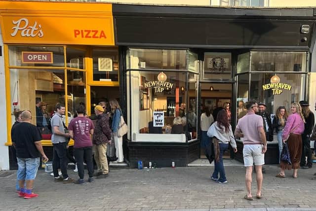 People enjoying both Pat's Pizza and Newhaven Tap on the High Street.