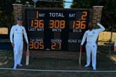 Ali Kent and Danul Dassanayake proudly stand next to their record breaking scoreboard. 