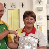 On the Adur League final night, John O'Connell, Lancing captain, presents the winning shield to Jan Bibby, Southwick captain