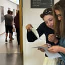 Students open their GCSE results.