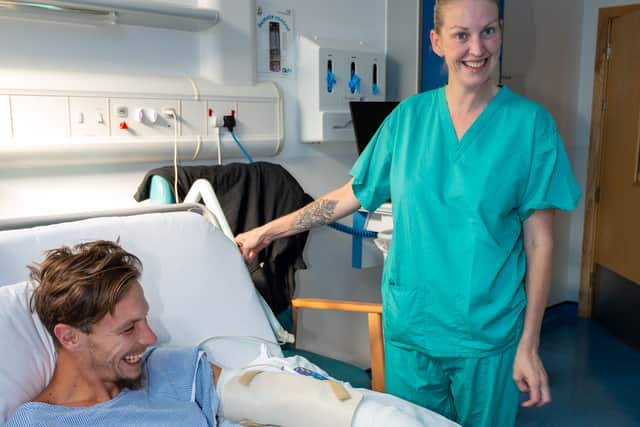 A nurse caring for a patient at Queen Victoria Hospital