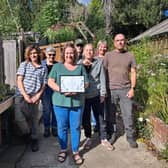 Greenhouse volunteers with their award