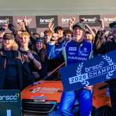 The TNR team celebrating stood around the car.