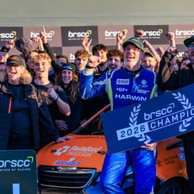 The TNR team celebrating stood around the car.
