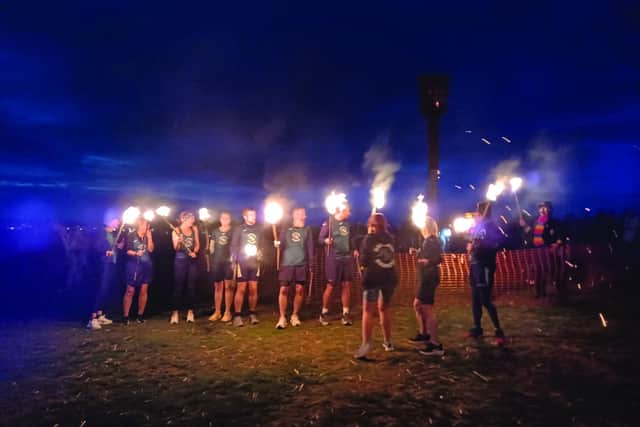 A team from Hastings Runners carries the flame fro the East Hill to the Bonfire Parade.