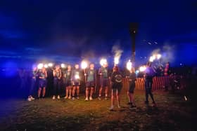 A team from Hastings Runners carries the flame fro the East Hill to the Bonfire Parade.