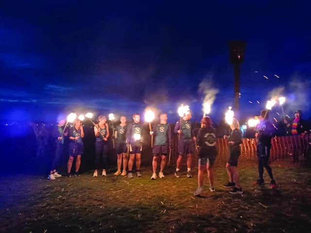 A team from Hastings Runners carries the flame fro the East Hill to the Bonfire Parade.