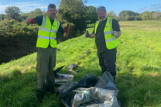 Two Volunteers with items rescued from the river