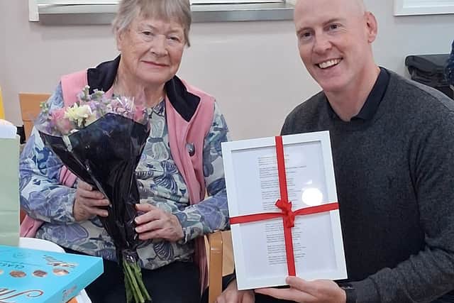 Kieran Mullan MP presenting resident Georgie Farrow with an award for her 80th anniversary poem in Sussex Housing & Care's residents' poetry competition.
