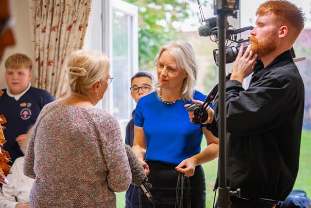 The Channel 5 News team chats with a resident at The Anchorage Care Home, joined by children from St Mary’s C of E Primary School in Pulborough.