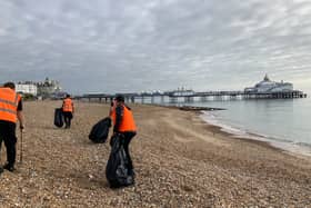 Offenders working to clear waste from Eastbourne beach.