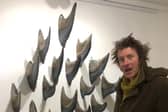 Artist Leigh Dyer with the metal fins being exhibited by At Sea, George Street, Hastings