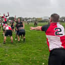 Stephen Cooper launches the ball