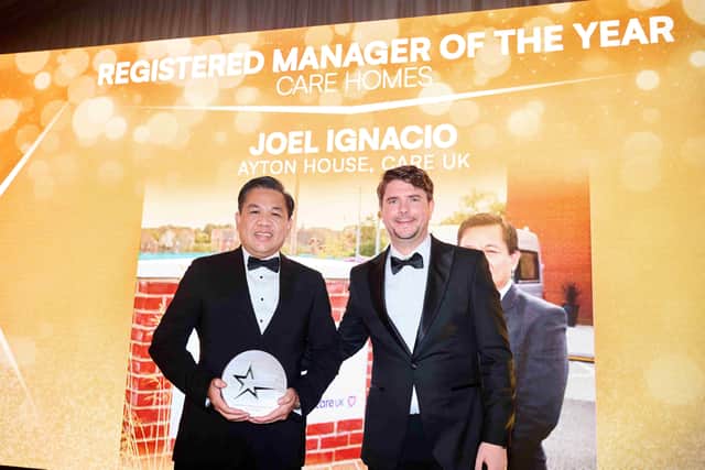 Louis Alexander presenting Joel Ignacio with his award