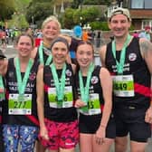 Louisa Geer, Helen Greck, Lindie Jooste, Dave Garratt, Charlie Long and Mia Long all smiles at the finish line of the Beachy Head 10K