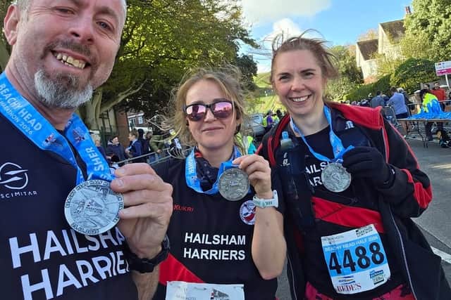 Harriers Chris Findlay-Geer, Gemma Payne and Charlie Long at the finish of the Beachy Head Half Marathon