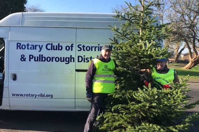 Rotarians Ken Collins & Mike Webster collecting Christmas trees.