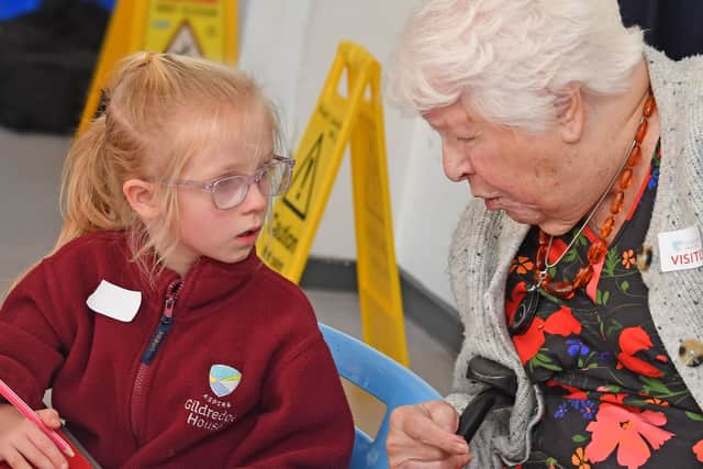 Mary Corin, 94, chats with a youngster