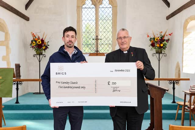 Jake Priddle (Marketing Manager at BRICS) hands over the cheque to Reverend Stephen Davies (Rector of Earnley Church)