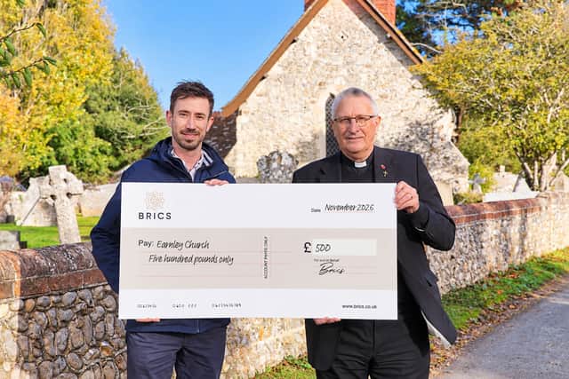 Jake Priddle (Marketing Manager at BRICS) hands over the cheque to Reverend Stephen Davies (Rector of Earnley Church)