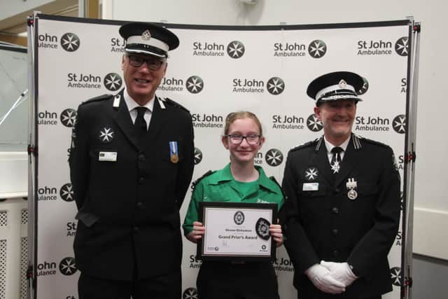 Eleanor Richardson with St John Ambulance County President Alex Ingham-Clark (Left) and County Commissioner Darren Owen (Right).