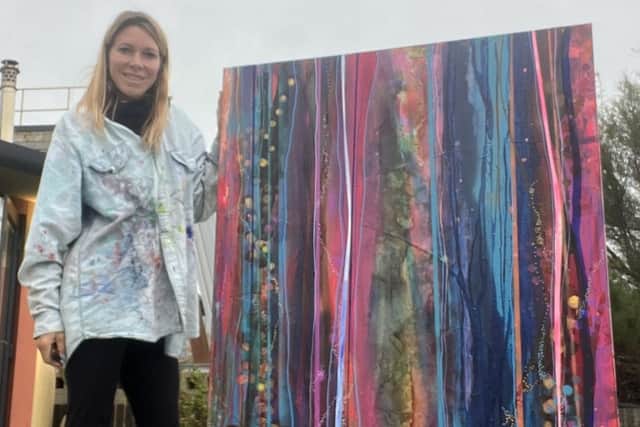 Artist Sophie Garwood with her painting Whispering Meadow (100 x 150cm, mixed media)