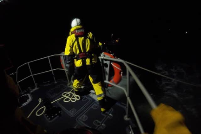 RNLI crews work to save the stricken vessel
