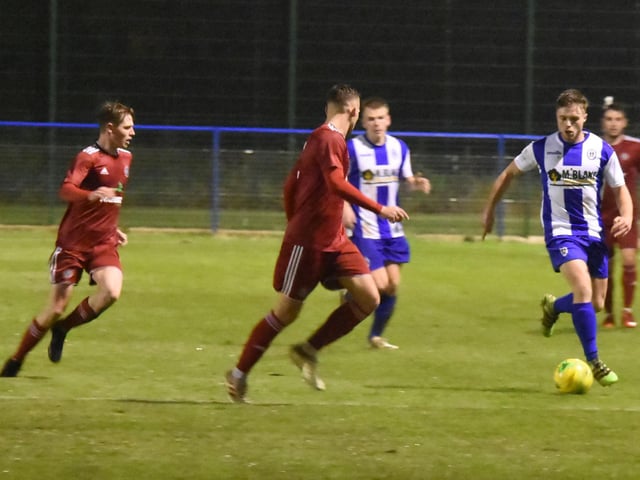 Tom Summerfield brings the ball out of defence.
