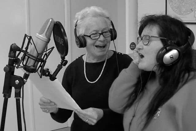 Jacqui Pullen, right, recording the Christmas song