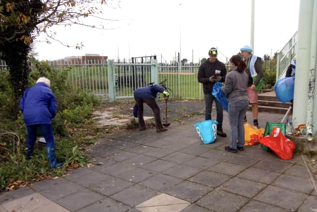 Volunteers tidying the memorial garden