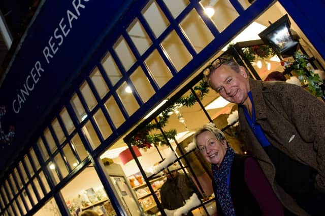 Hugh Bonneville at Cancer Research UK - one of the winners of Chichester BIDs Christmas Window Display Competition SUS-191127-143908001