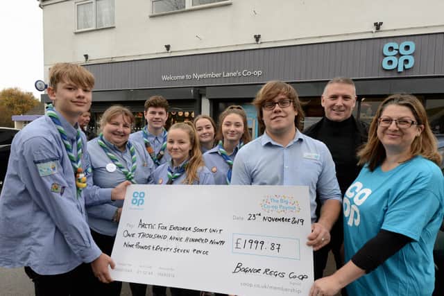 ks1906377-1 Co-Op  Cheques   phot kate Jamie Barrtle, store manager at the Co-op in Nyetimber, Nick Witham, area manager and Mel Twinley, Co-op member pioneer, right, hand over a cheque for ?1,999.9 to the Artic Fox Explrer Scout unit.ks1906377-1 SUS-191124-103649008
