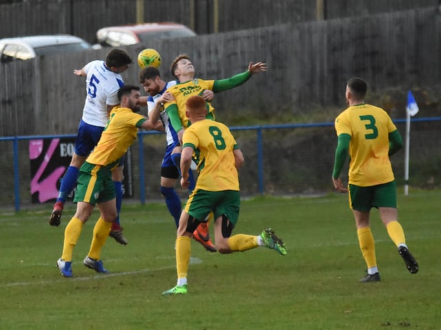 Nathan Cooper and Lloyd Cotton combine to clear the ball.
