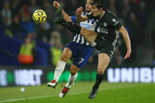Neal Maupay applies pressure to Leicester City's defender Caglar Soyuncu