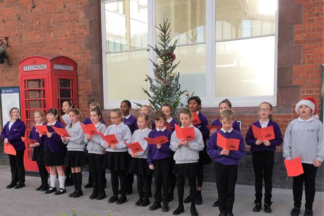Southway Primary School pupils singing loud for all to hear at Bognor Regis railway station