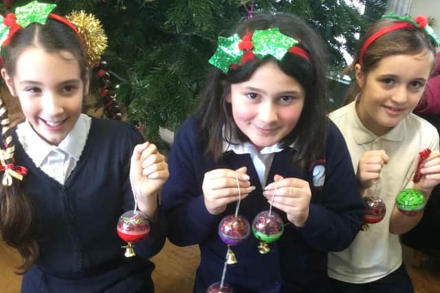 Children from Georgian Gardens Primary School in Rustington with Christmas decorations they made for Angmering Railway Station