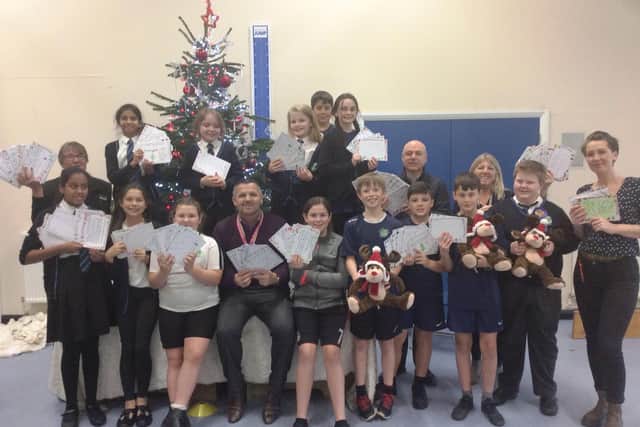 Orchards Junior School pupils with the cuddly Christmas toys from Haskins Roundstone