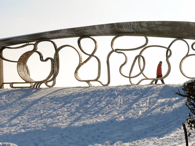 Sun shines through The Longest Bench in Littlehampton onto the snow covered green in December 2010