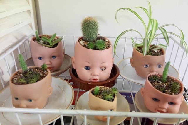 Oddities include plant pot holders made from dolls' heads