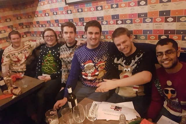 Xavier Voigt-Hills and his colleagues wearing their Christmas jumpers